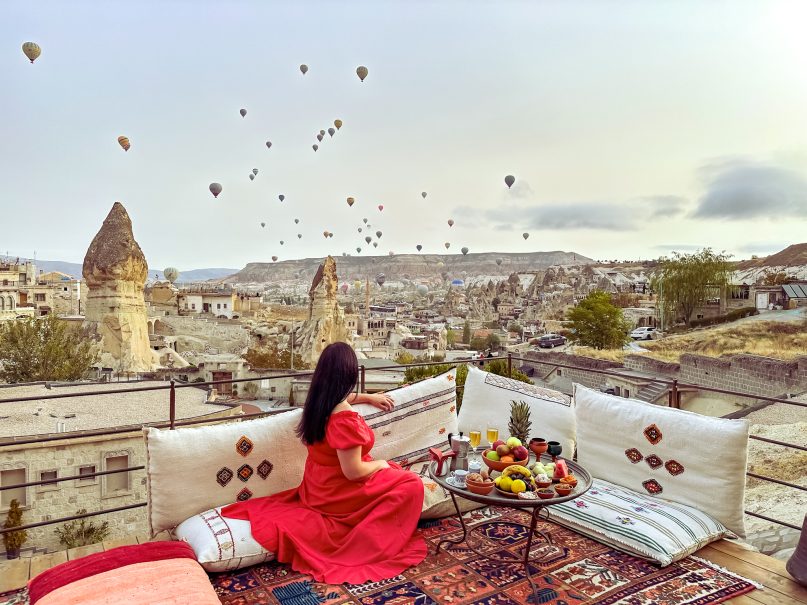 a woman sitting on a couch overlooking a city