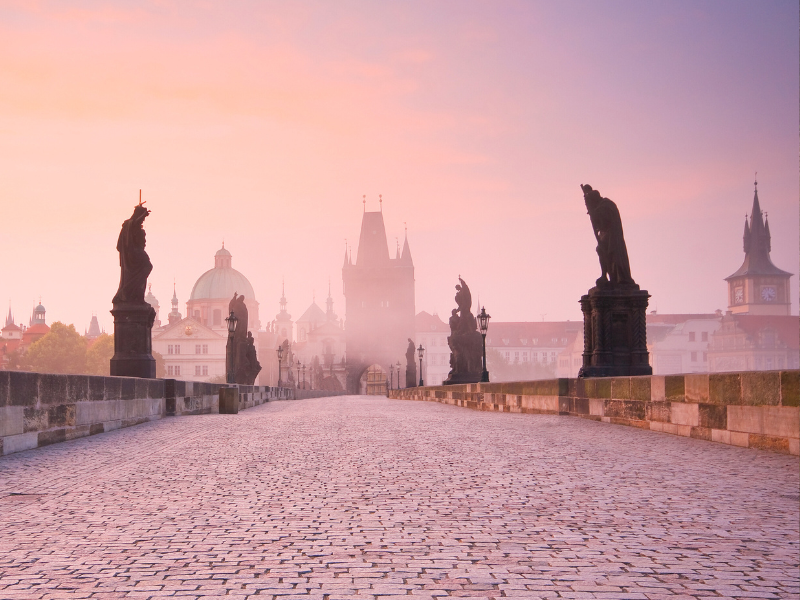 Prague - a stone bridge with statues on it